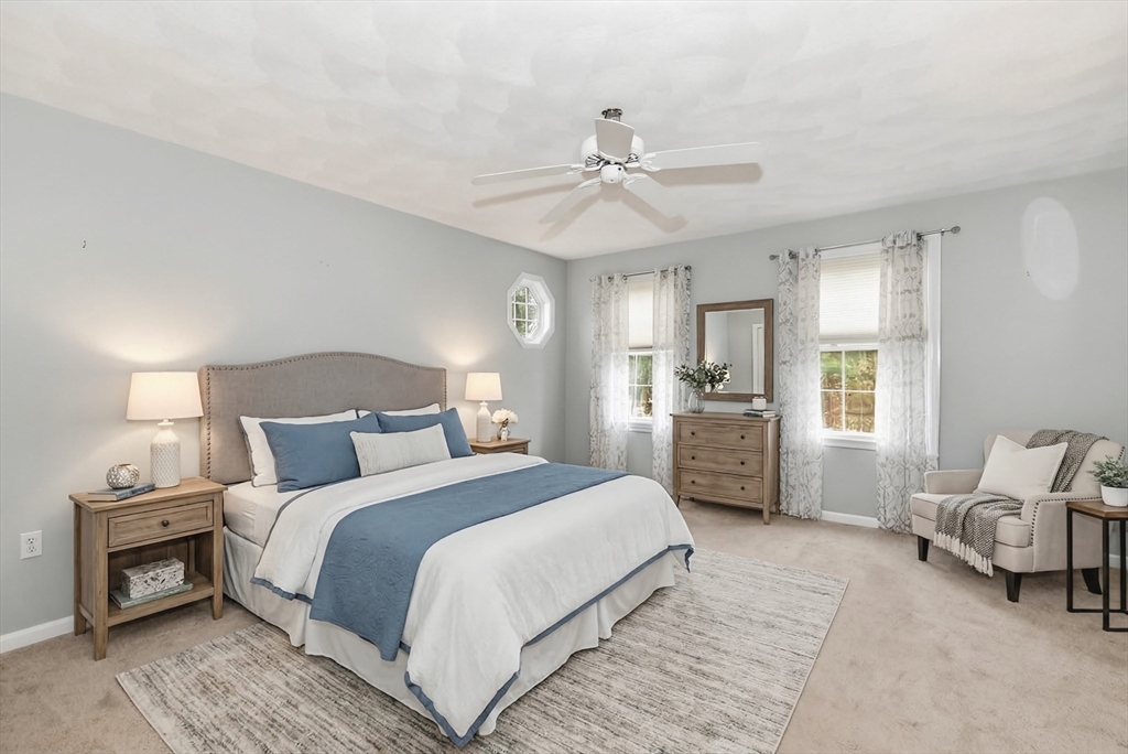 142 River Road Pepperell, MA 01463 - Photo 23 of 41 a bedroom with a bed and a chandelier
