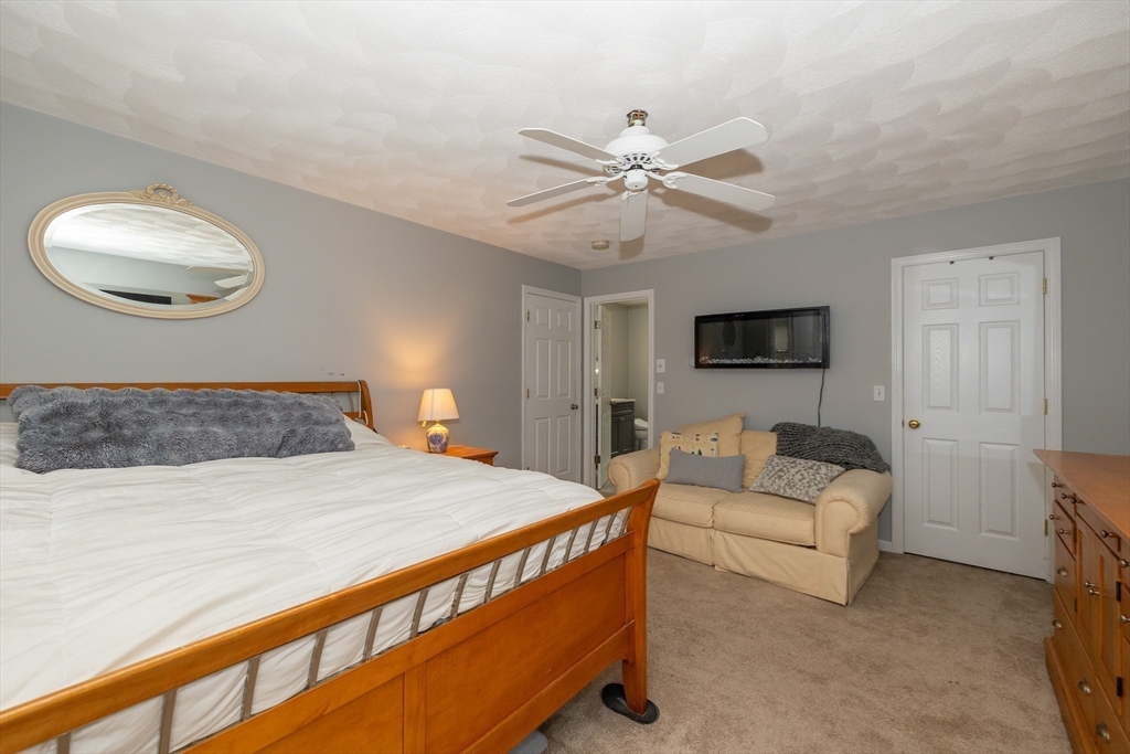 142 River Road Pepperell, MA 01463 - Photo 24 of 41 a bedroom with a bed and a chandelier