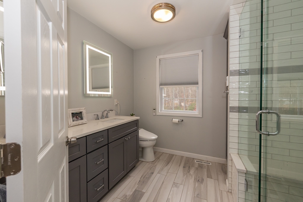 142 River Road Pepperell, MA 01463 - Photo 25 of 41 a bathroom with a double vanity sink toilet and shower