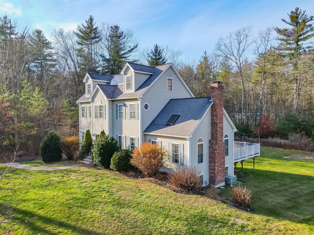 142 River Road Pepperell, MA 01463 - Photo 4 of 41 a front view of a house with a yard table and chairs