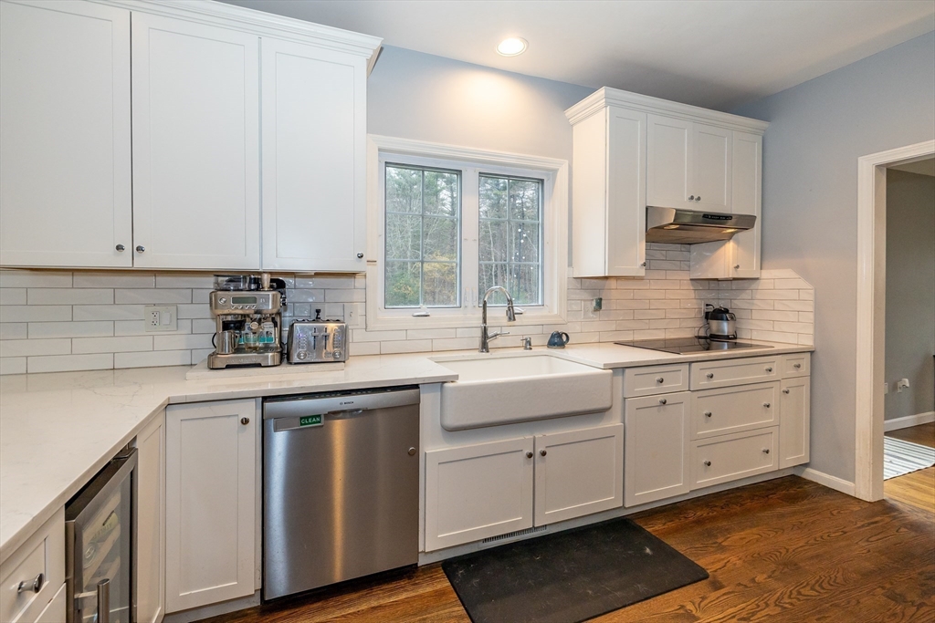 142 River Road Pepperell, MA 01463 - Photo 10 of 41 a kitchen with white cabinets and sink