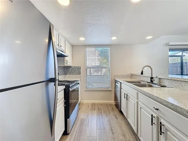 a kitchen with a sink and cabinets