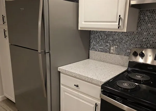 a view of a kitchen with a sink and wooden floor