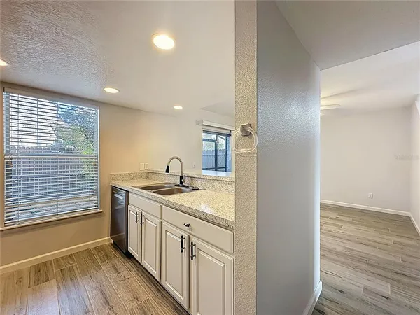 a kitchen with granite countertop a refrigerator and a stove