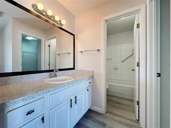 a white toilet and tub sitting next to a bathroom sink