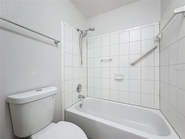 a bathroom with a tub and toilet