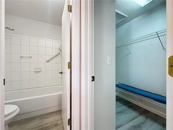 a view of a room with wooden floor