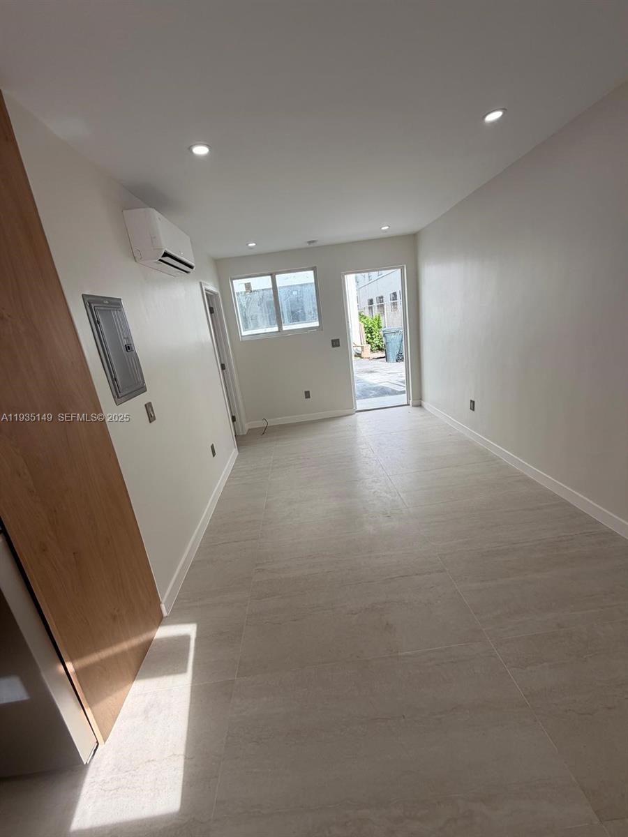 2436 Southwest 7th Street, Unit 12 Miami, FL 33135 - Photo 2 of 8 an empty room with windows