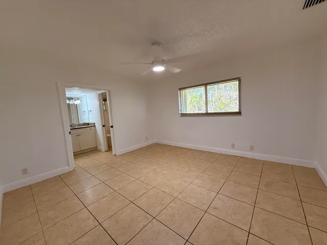 an empty room with a empty space and windows