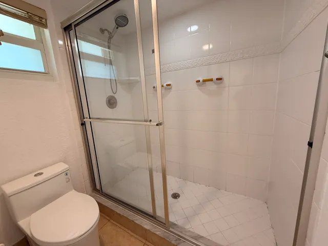 a bathroom with a toilet and a shower
