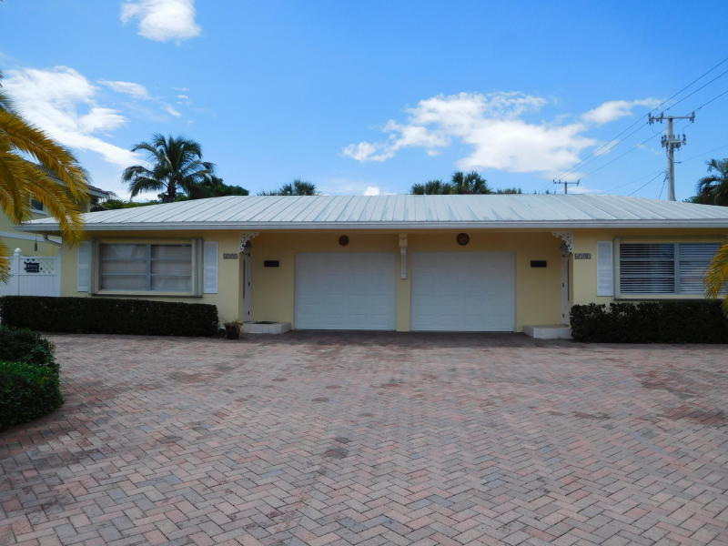 6797 Northeast 7th Avenue Boca Raton, FL 33487 - Photo 20 of 21 a front view of a house with a garden and entryway