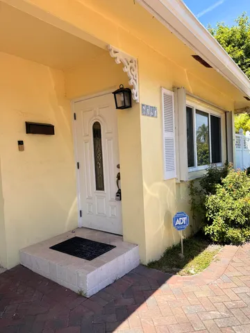 a front view of a house with white walls