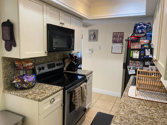 a kitchen with stainless steel appliances granite countertop a sink and cabinets