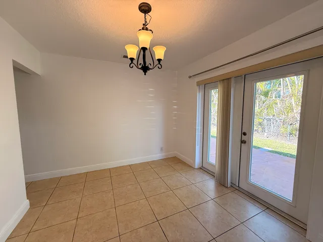 a view of a room with a projector and furniture