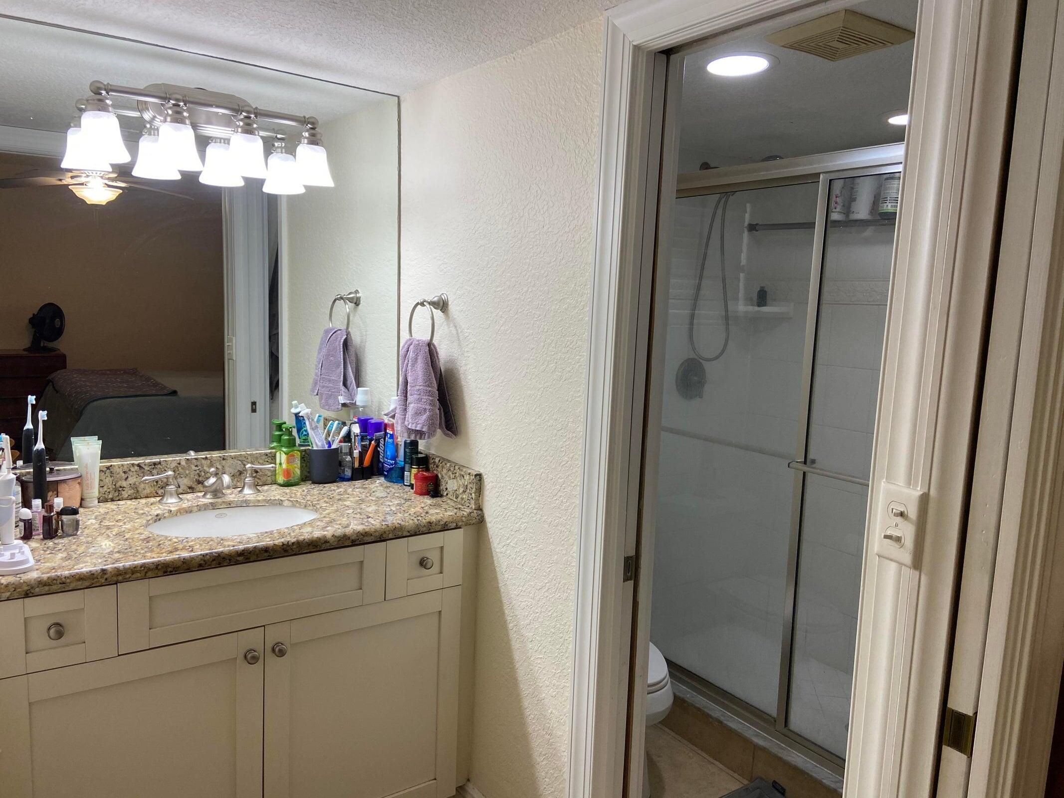 6797 Northeast 7th Avenue Boca Raton, FL 33487 - Photo 10 of 21 a bathroom with a sink vanity and a mirror