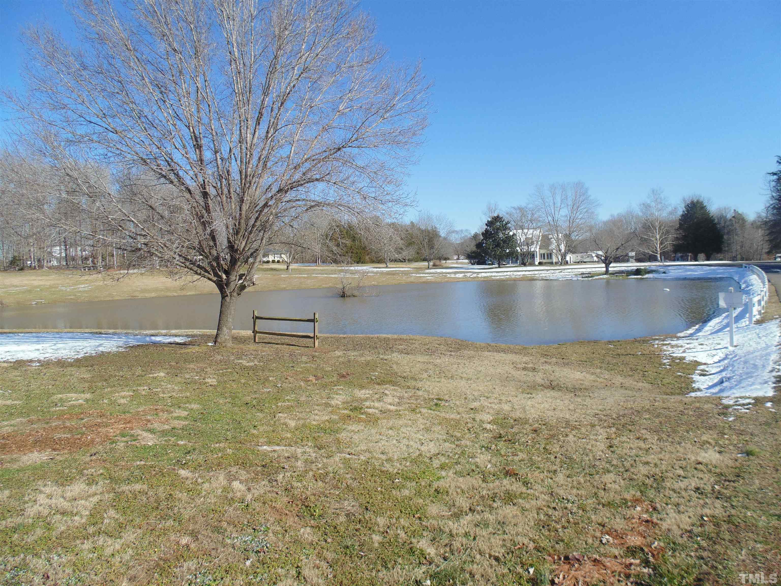 7-8 Stoney Mountain Road Rougemont, NC 27572 - Photo 1 of 31 a view of a lake with a yard and large trees