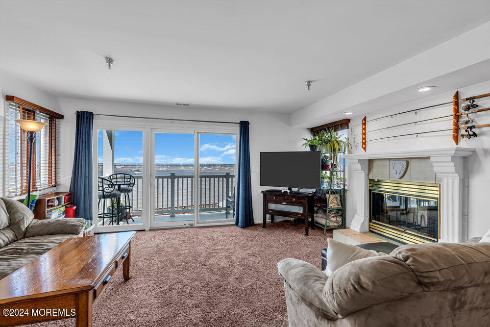 135 1st Street, Unit 2F Keyport, NJ 07735 - Photo 12 of 46 a living room with furniture and a fireplace