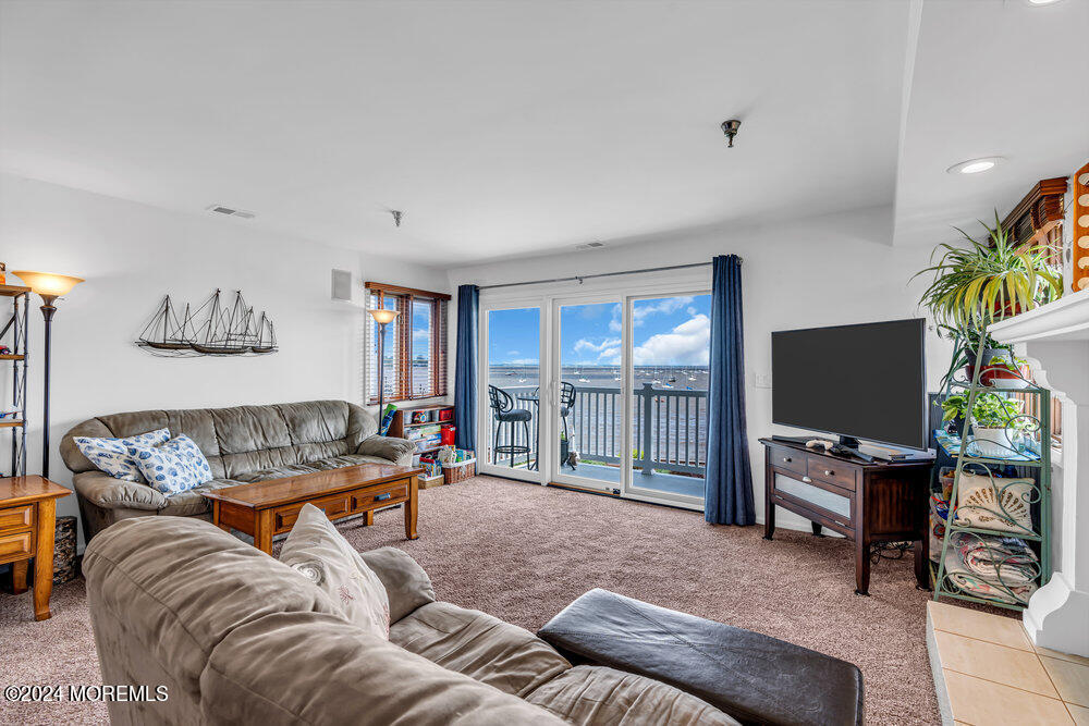 135 1st Street, Unit 2F Keyport, NJ 07735 - Photo 13 of 46 a living room with furniture and a flat screen tv