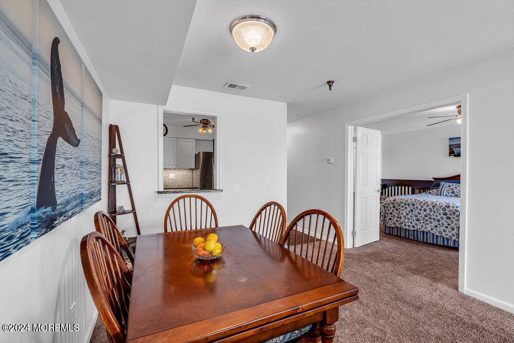 135 1st Street, Unit 2F Keyport, NJ 07735 - Photo 16 of 46 a view of a dining room with furniture window and wooden floor