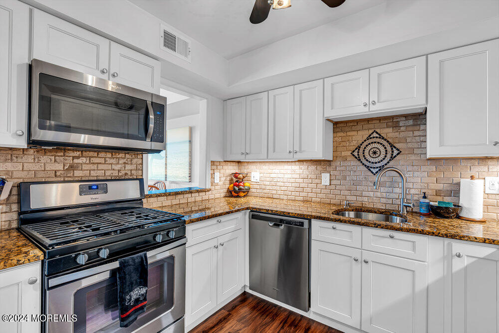 135 1st Street, Unit 2F Keyport, NJ 07735 - Photo 19 of 46 a kitchen with granite countertop a stove sink and cabinets