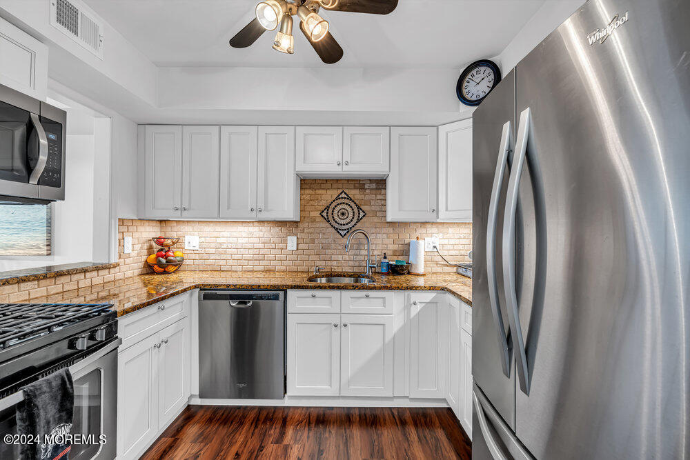 135 1st Street, Unit 2F Keyport, NJ 07735 - Photo 21 of 46 a kitchen with stainless steel appliances granite countertop a refrigerator and a stove top oven