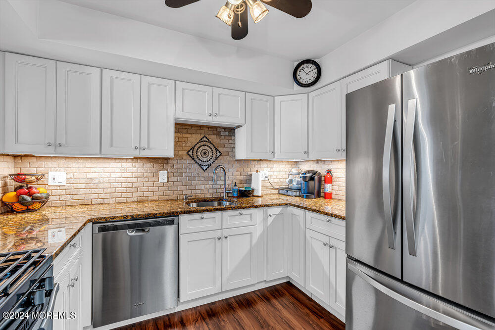 135 1st Street, Unit 2F Keyport, NJ 07735 - Photo 22 of 46 a kitchen with stainless steel appliances granite countertop a refrigerator sink and cabinets