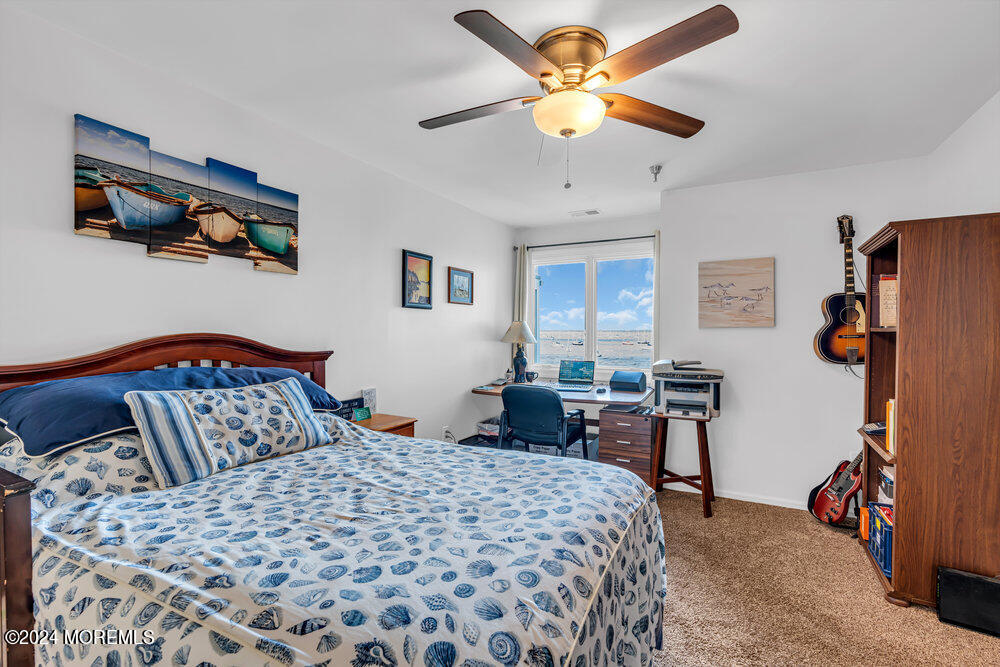 135 1st Street, Unit 2F Keyport, NJ 07735 - Photo 24 of 46 a bedroom with a bed and a chandelier