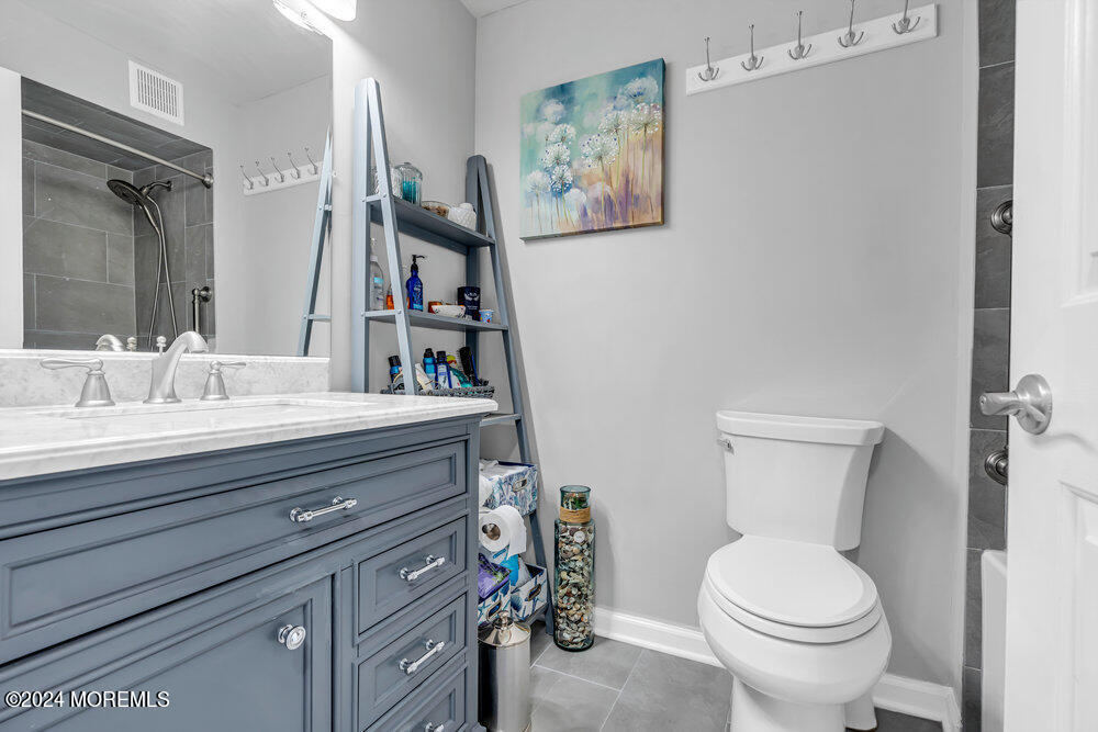 135 1st Street, Unit 2F Keyport, NJ 07735 - Photo 27 of 46 a bathroom with a toilet sink and mirror