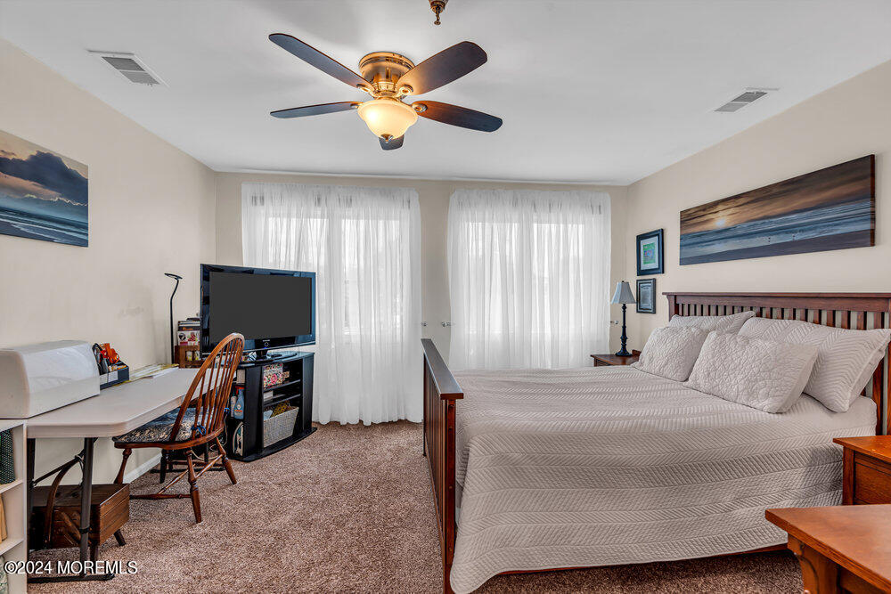 135 1st Street, Unit 2F Keyport, NJ 07735 - Photo 31 of 46 a bedroom with a bed and a flat screen tv