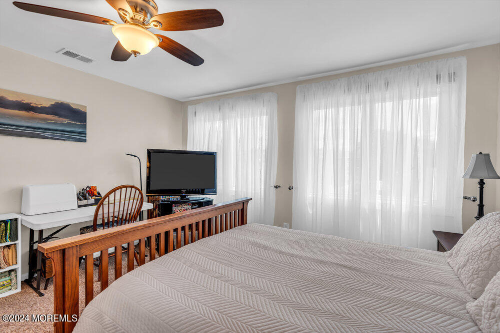 135 1st Street, Unit 2F Keyport, NJ 07735 - Photo 32 of 46 a bedroom with furniture and a flat screen tv