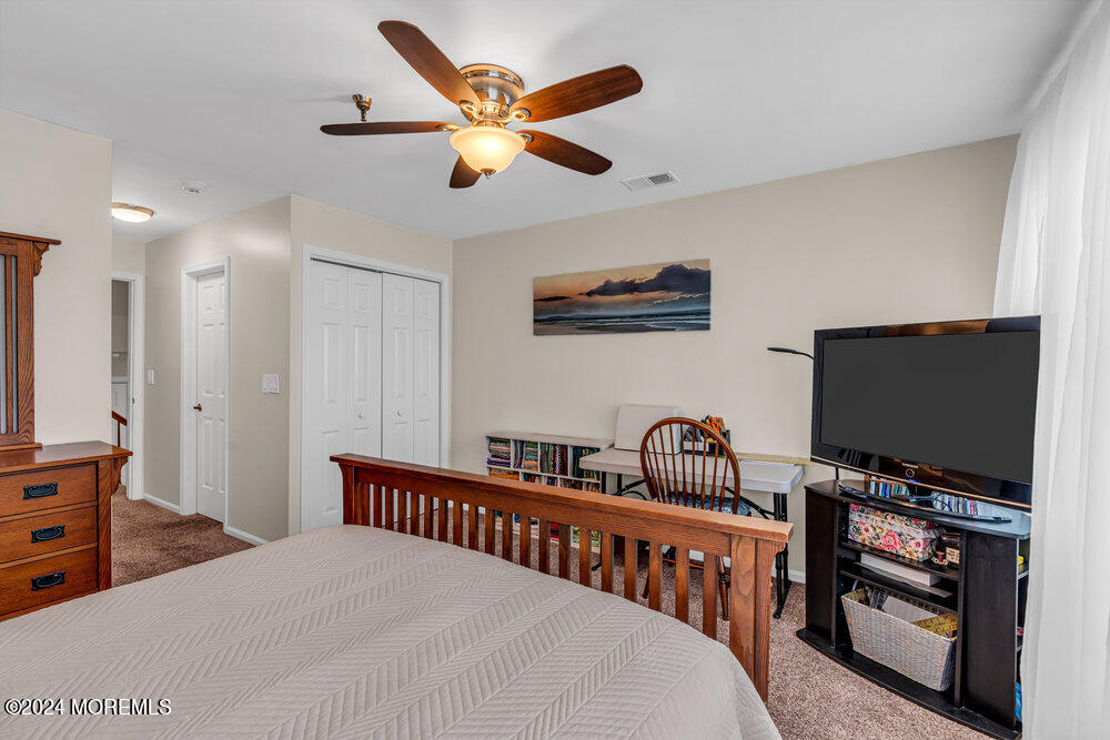 135 1st Street, Unit 2F Keyport, NJ 07735 - Photo 33 of 46 a bedroom with furniture and a flat screen tv