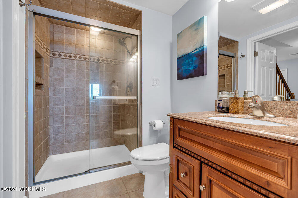 135 1st Street, Unit 2F Keyport, NJ 07735 - Photo 34 of 46 a bathroom with a granite countertop sink toilet and shower