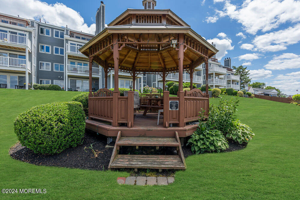 135 1st Street, Unit 2F Keyport, NJ 07735 - Photo 41 of 46 a view of a chair and table in the garden in front of a building