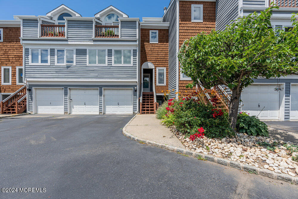 135 1st Street, Unit 2F Keyport, NJ 07735 - Photo 7 of 46 a front view of a house with a yard and garage