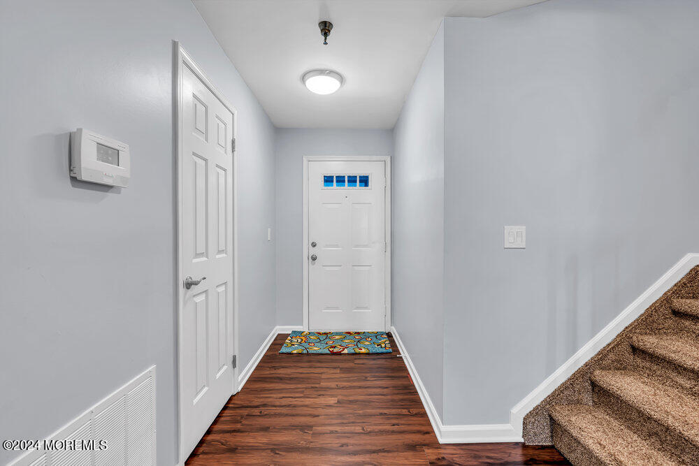 135 1st Street, Unit 2F Keyport, NJ 07735 - Photo 10 of 46 a view of a hallway with wooden floor and staircase
