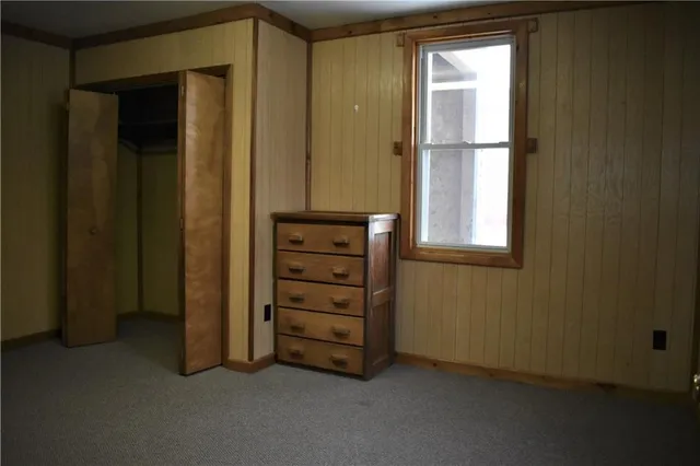 an empty room with windows and closet