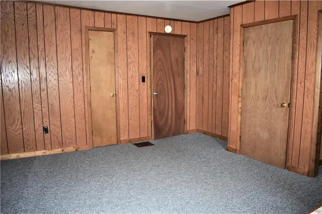 a view of an empty room with a wooden walls
