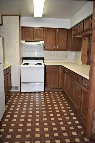 a kitchen with a refrigerator and a sink