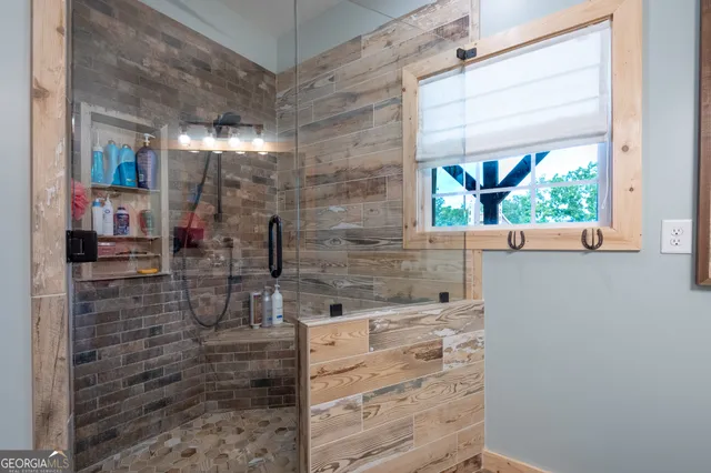 a bathroom with a shower and a sink