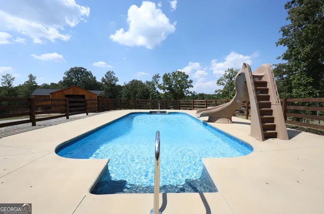 a view of a swimming pool with a lounge chair