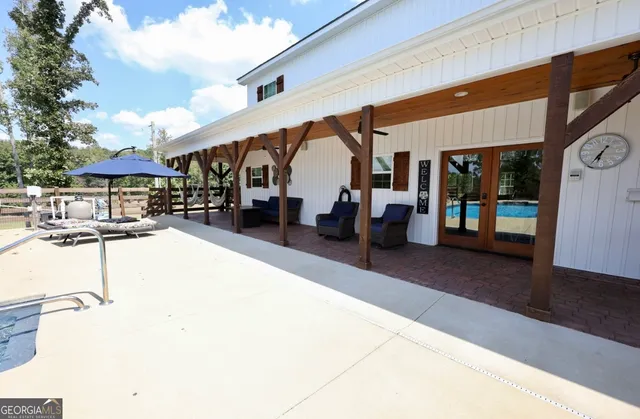 a swimming pool view with a outdoor seating