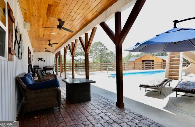 a view of living room with furniture and a floor to ceiling window
