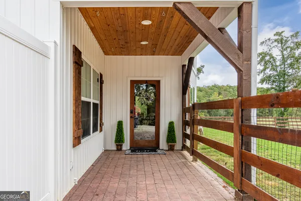 a view of a porch with wooden floor and stairs