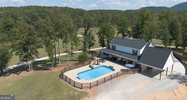 a view of a backyard with plants and a patio