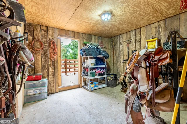 a hallway with stairs and a wooden floor