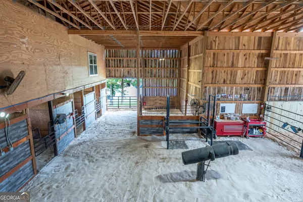 a kitchen with stainless steel appliances a refrigerator a sink dishwasher a stove and a dining table with wooden floor