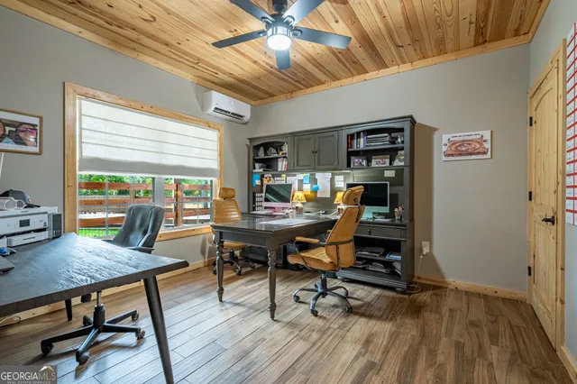 a view of a workspace with furniture and a window