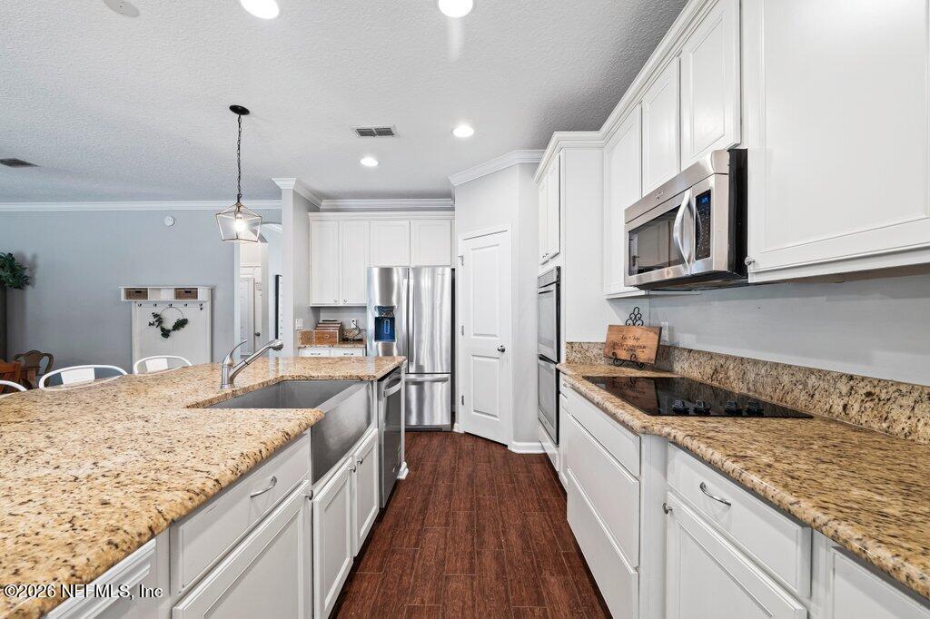 81015 Lockhaven Drive Yulee, FL 32097 - Photo 14 of 55 a kitchen with stainless steel appliances granite countertop a sink stove and refrigerator