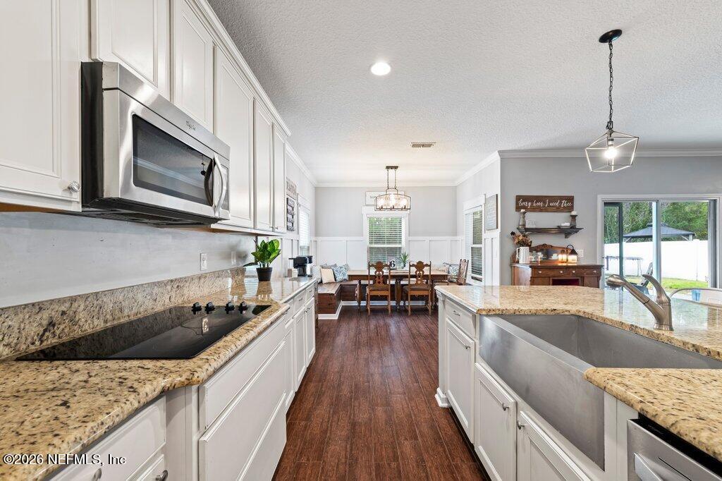 81015 Lockhaven Drive Yulee, FL 32097 - Photo 15 of 55 a kitchen with stainless steel appliances granite countertop a sink dishwasher stove and oven with wooden floor