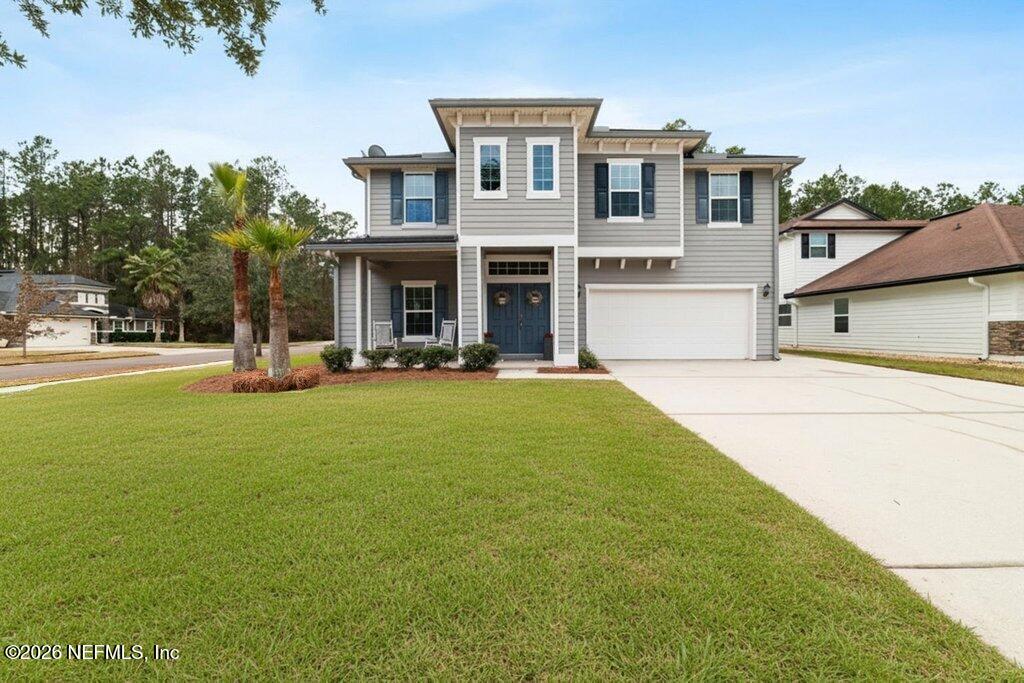81015 Lockhaven Drive Yulee, FL 32097 - Photo 2 of 55 a front view of a building with garden